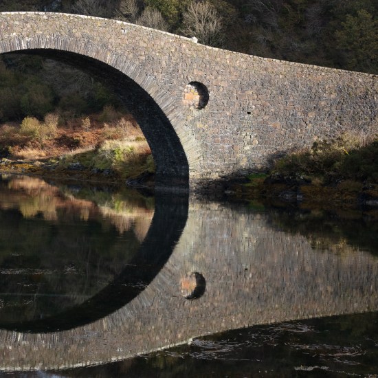 Clachan Bridge I, which links the mainland to the island of Seil and is also known as the Bridge over the Atlantic, Argyll, Scotland.